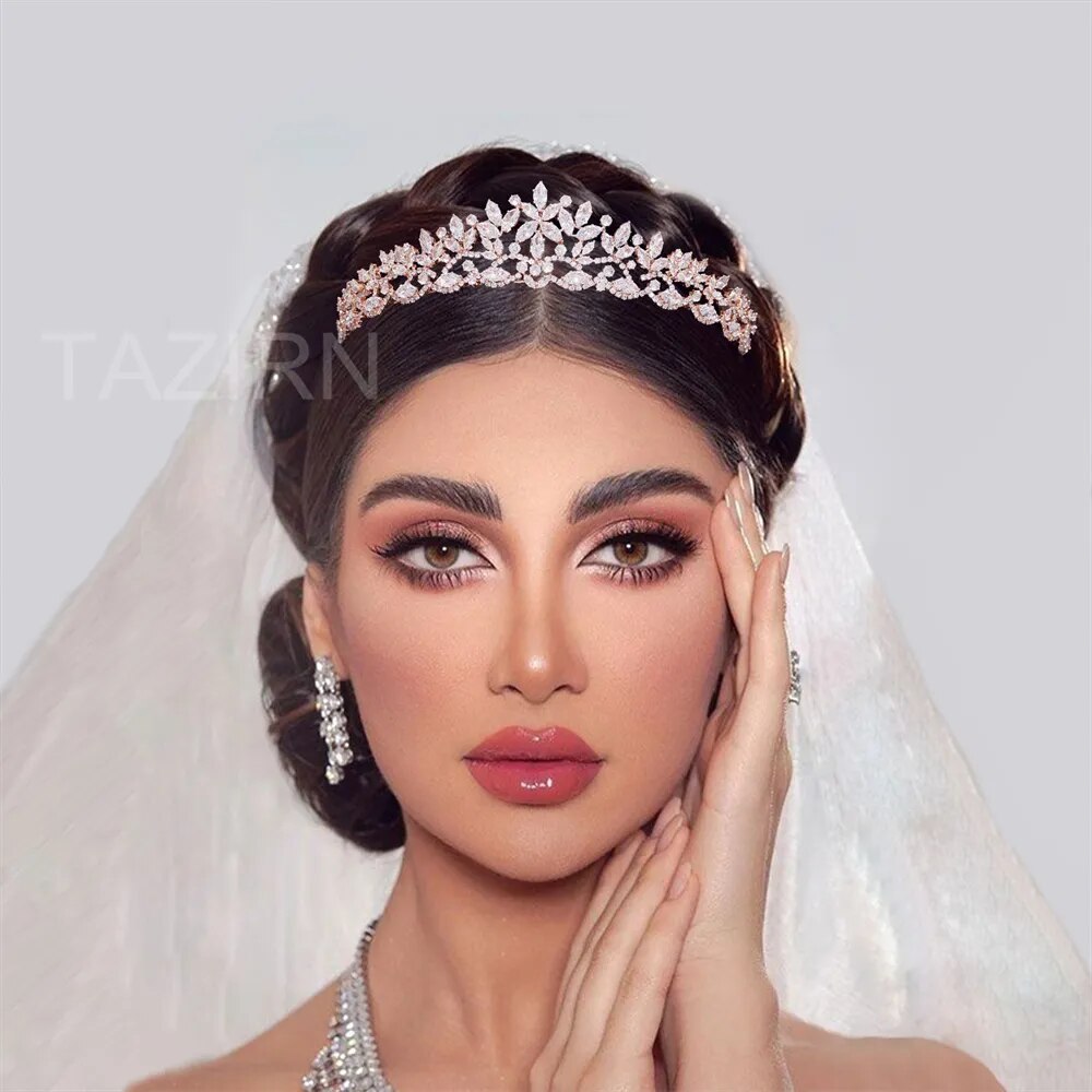 Headshot portrait of a bride wearing a rose gold floral CZ bridal crown tiara adorned with marquise cubic zirconia stones and a matching wedding veil.