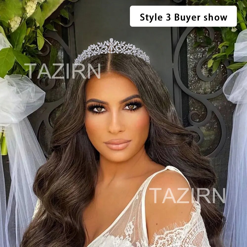 Bridal presentation photo of a woman with long wavy dark hair wearing a classic silver crystal wedding crown tiara.