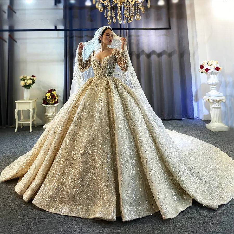 Professional studio shot of a high-neck long-sleeve beaded ball gown wedding dress, showcasing the high-end sparkle and majestic princess silhouette.