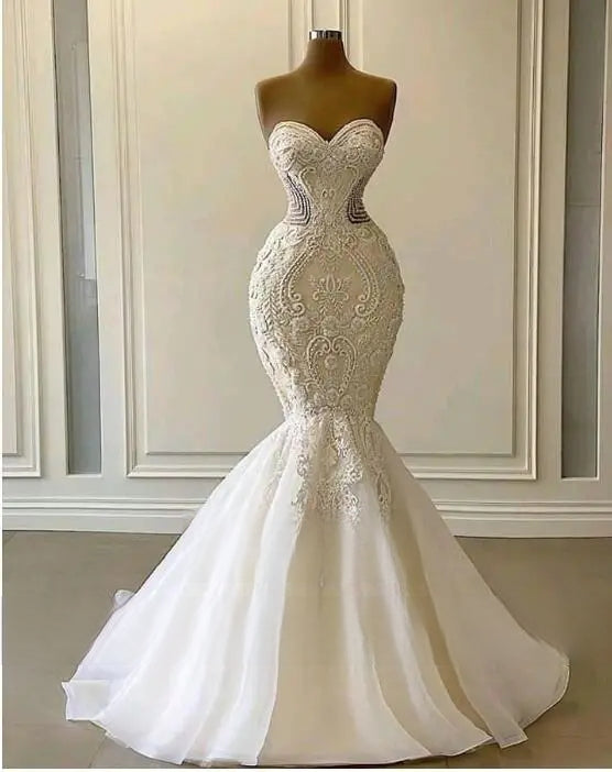 Front view of the glamorous strapless mermaid wedding dress displayed on a mannequin, showcasing its fitted sexy silhouette and dramatic flared skirt.