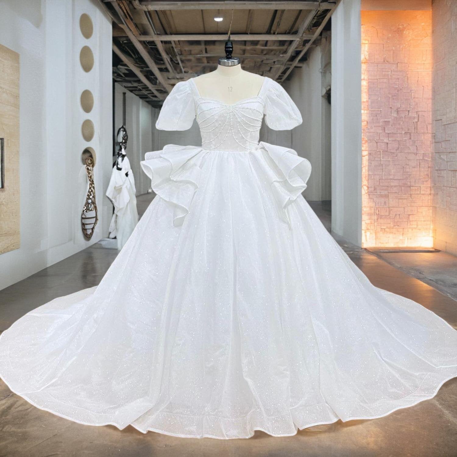 Front view of a luxury glitter ball gown bridal dress with a sweetheart neckline and short sleeves displayed on a mannequin.