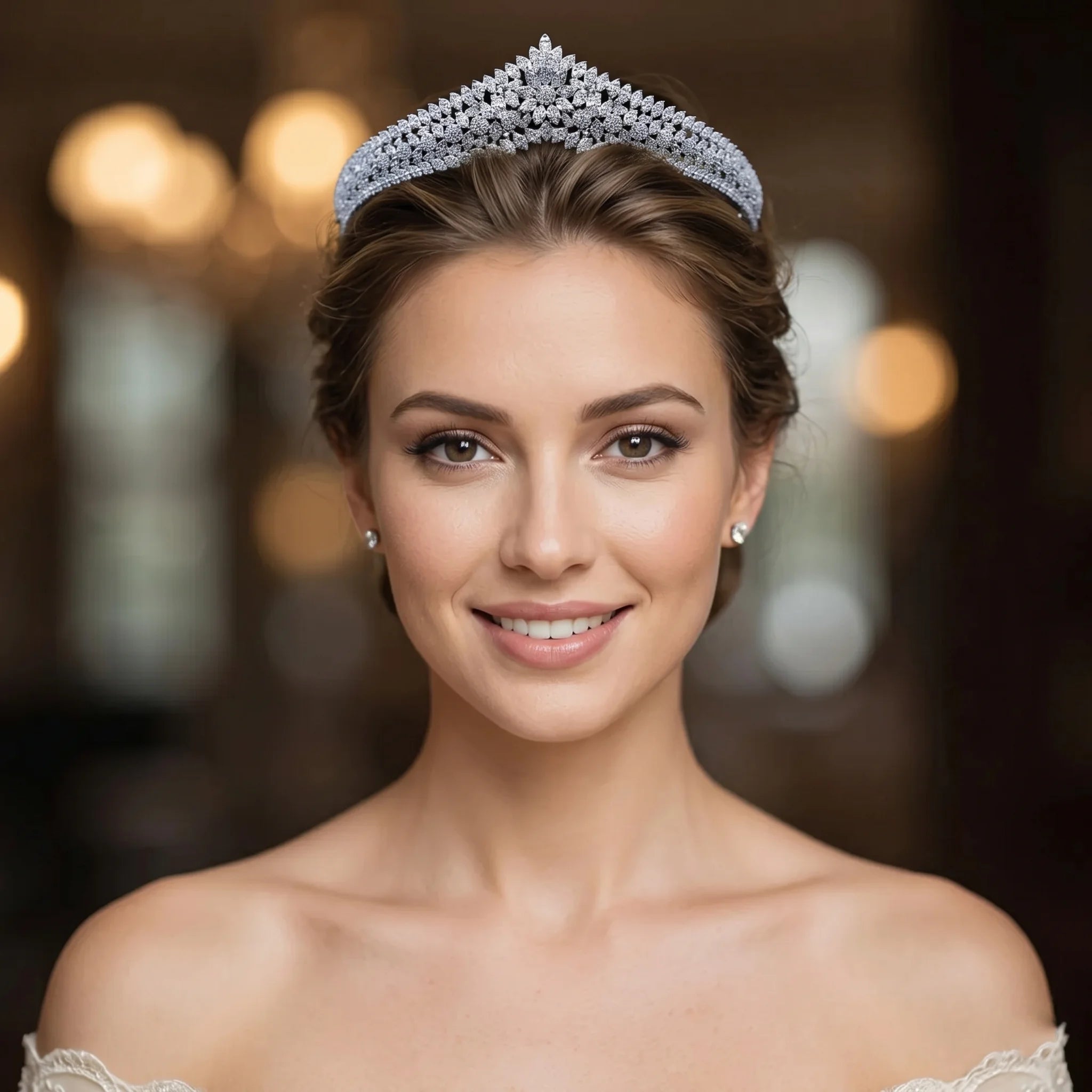 Close-up portrait of a smiling bride wearing a gorgeous crystals princess tiara with an intricate floral diamond pattern.