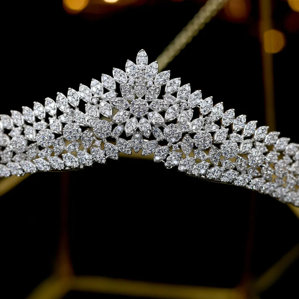 Close-up view of the central pointed peak pattern featuring a detailed rhinestone flower motif on the princess bridal tiara.