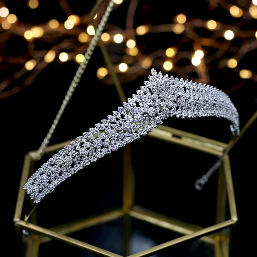 Full view of the elegant nupcial bridal hair tiara collection piece beautifully resting on a gold and glass display display holder.