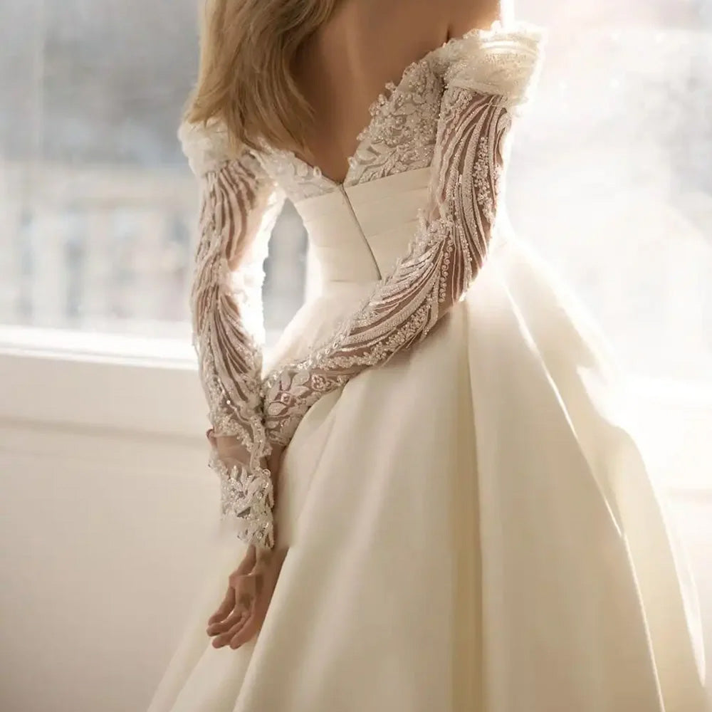 Rear view of an elegant mermaid wedding dress on a mannequin, showcasing the detailed lace back and the attachment for the detachable train.