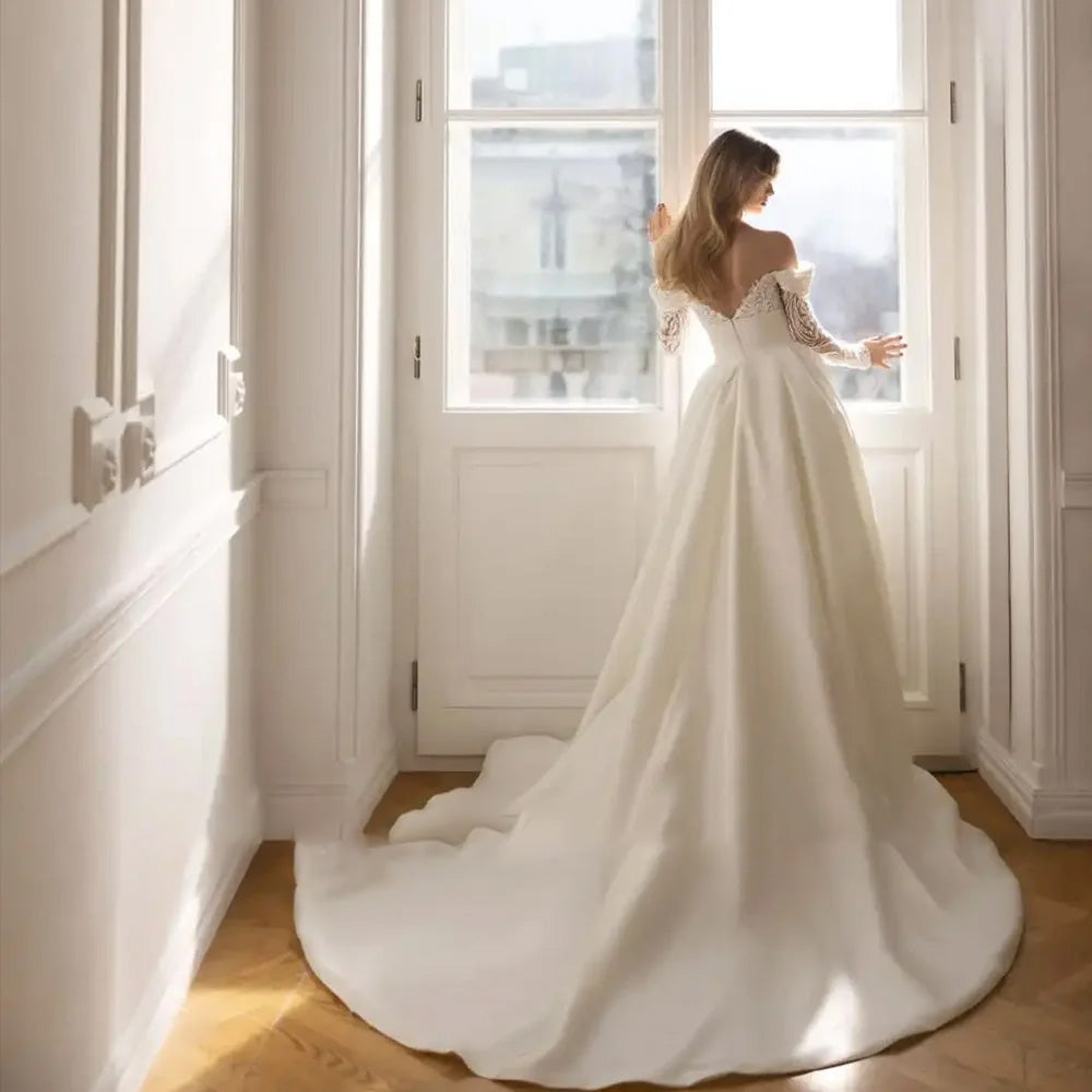 Studio portrait of a luxury long-sleeve mermaid wedding gown, emphasizing the refined bridal silhouette and sophisticated lace design.