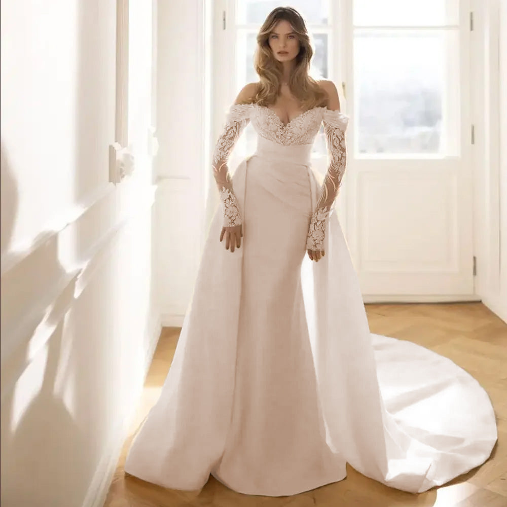A studio mannequin displaying the full front view of a luxury mermaid bridal gown with a detachable train, perfect for a grand entrance.