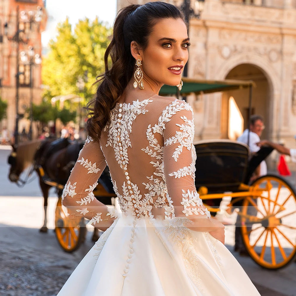 Close-up of an elegant bride wearing a half-sleeve lace wedding dress with detailed beaded appliques on the bodice.