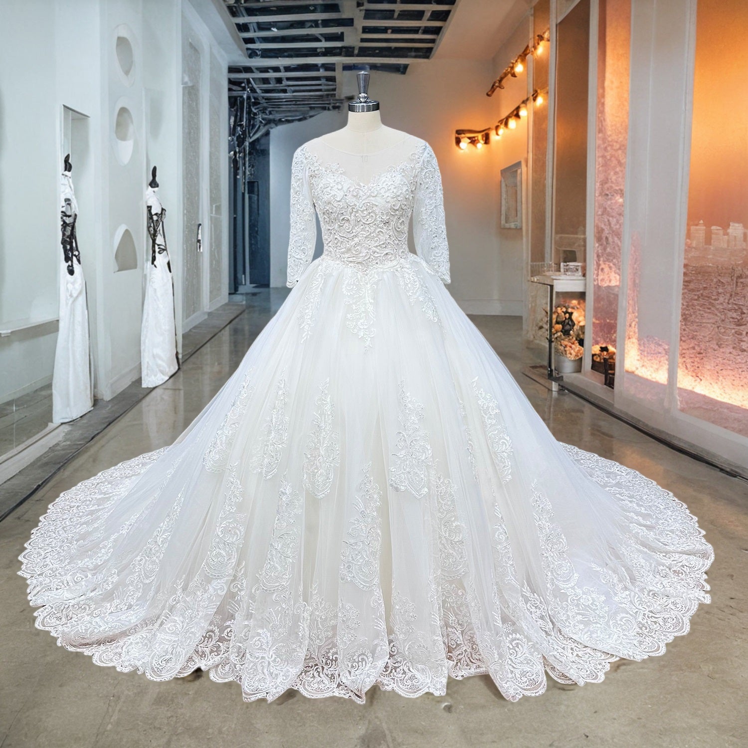Full front display of an ivory half-sleeve ball gown wedding dress with pearl embellishments on a showroom mannequin.