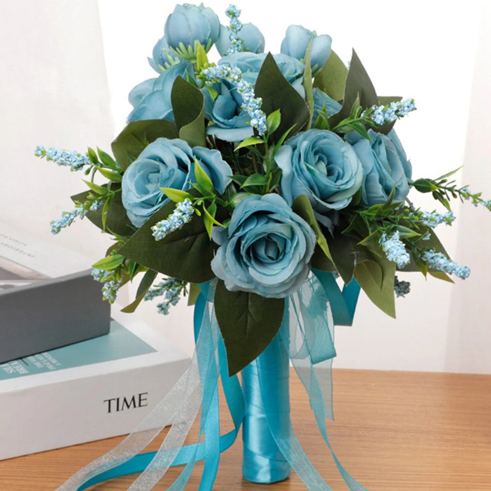 Front view of a handmade dusty blue silk rose bridal bouquet decorated with artificial foliage and coordinated sheer blue ribbons.