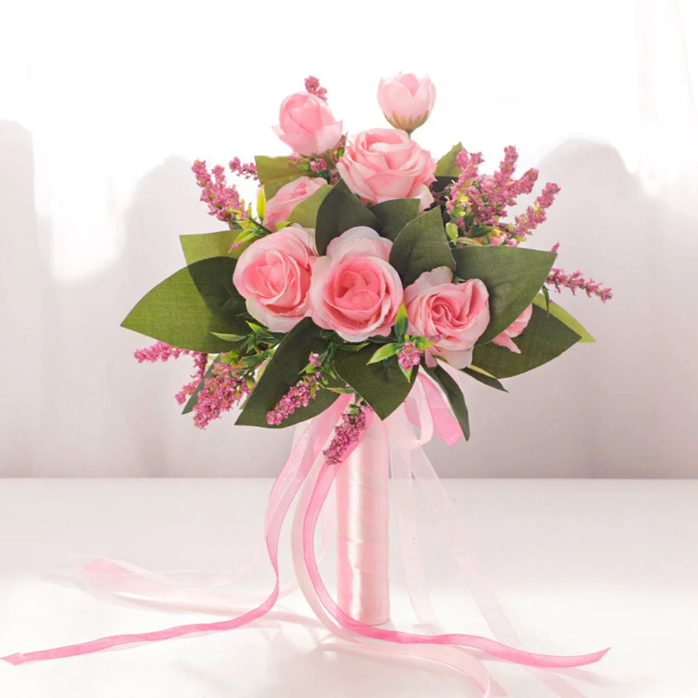 Front view of a handmade dusty blue silk rose bridal bouquet decorated with artificial foliage and coordinated sheer blue ribbons.