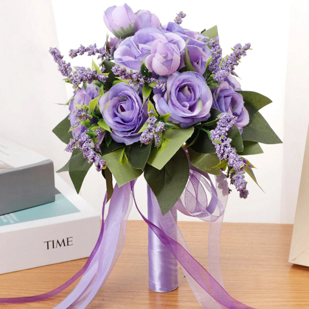 Front view of a handmade purple and lavender silk rose bridal bouquet decorated with artificial lavender sprigs, green foliage, and coordinated hanging sheer purple ribbons for wedding decor.