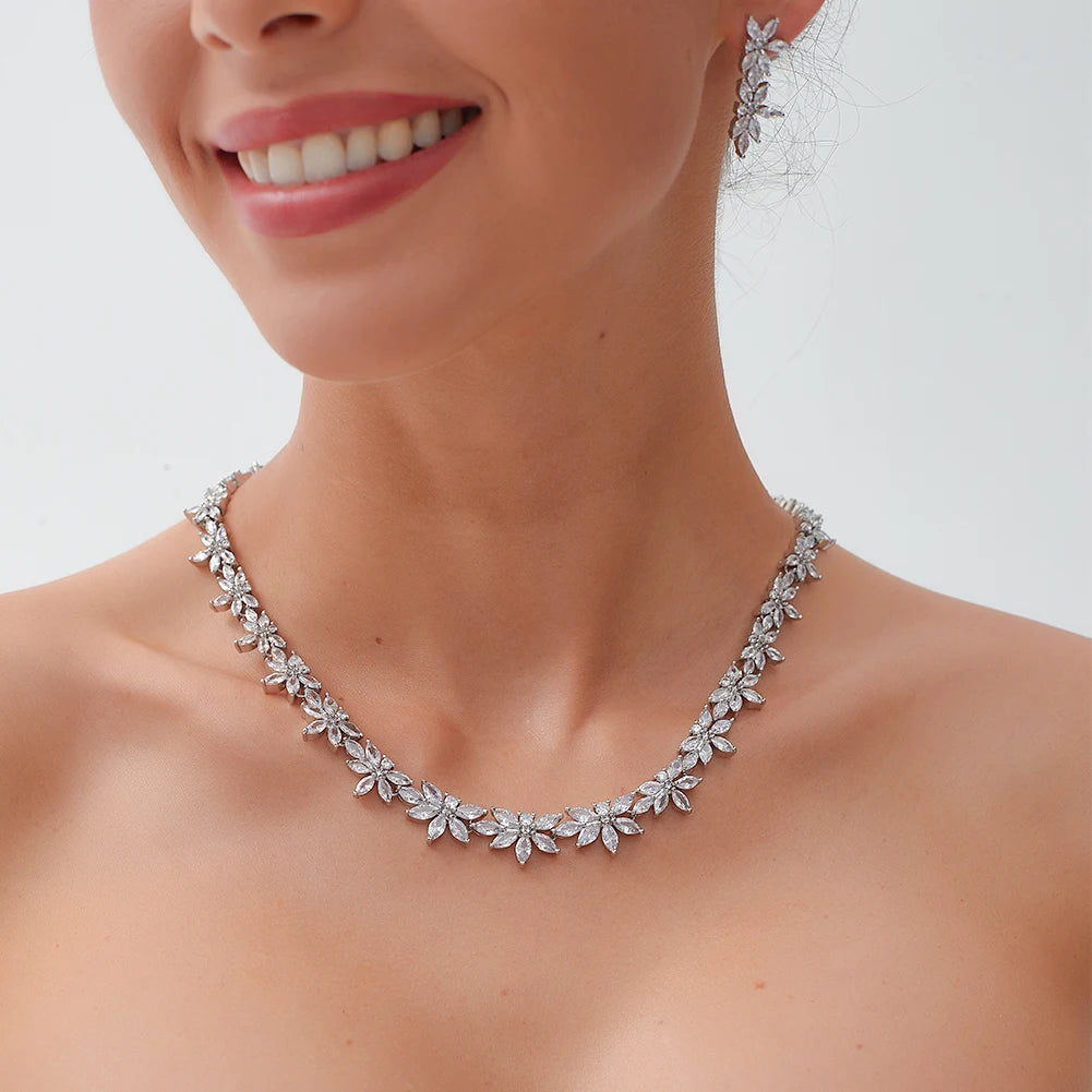 Close-up profile of a smiling model wearing a high-quality 2pcs crystal bridal necklace and matching marquise floral earrings.