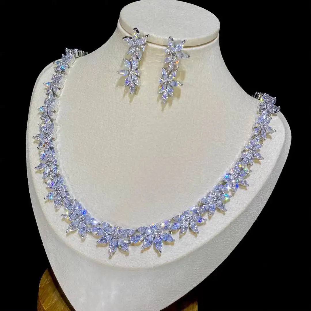 Premium 2pcs crystal bridal necklace and earring set highlighting the dense floral cluster design under soft display lighting.