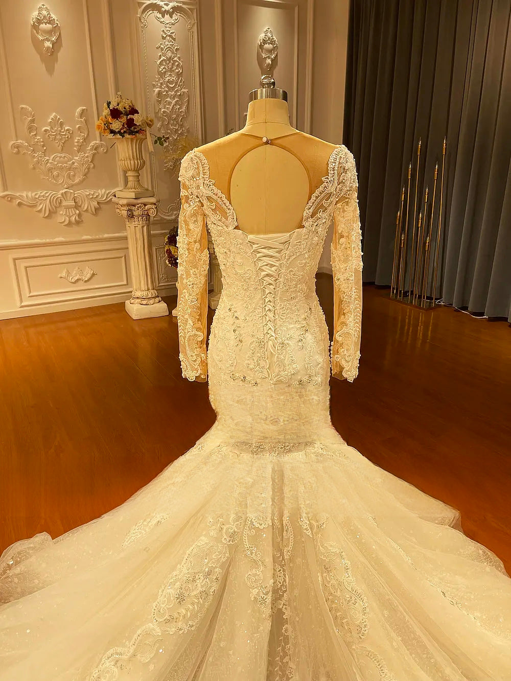 Rear view of the elegant bridal gown bodice highlighting a sophisticated keyhole back and traditional corset-style lace-up closure.
