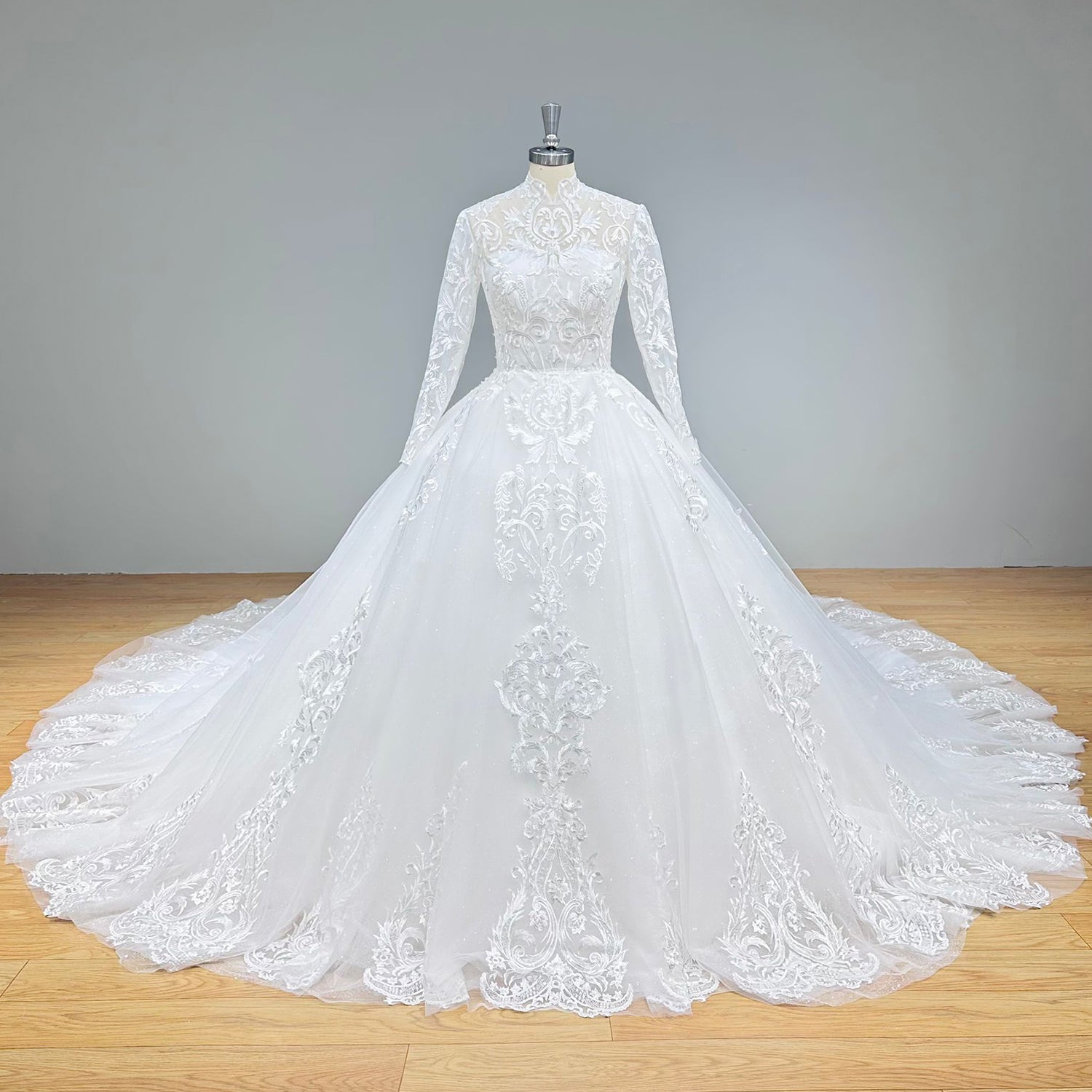 Detailed front view of a mock high collar bridal bodice emphasizing the textured lace applique placement and sheer illusion neckline.