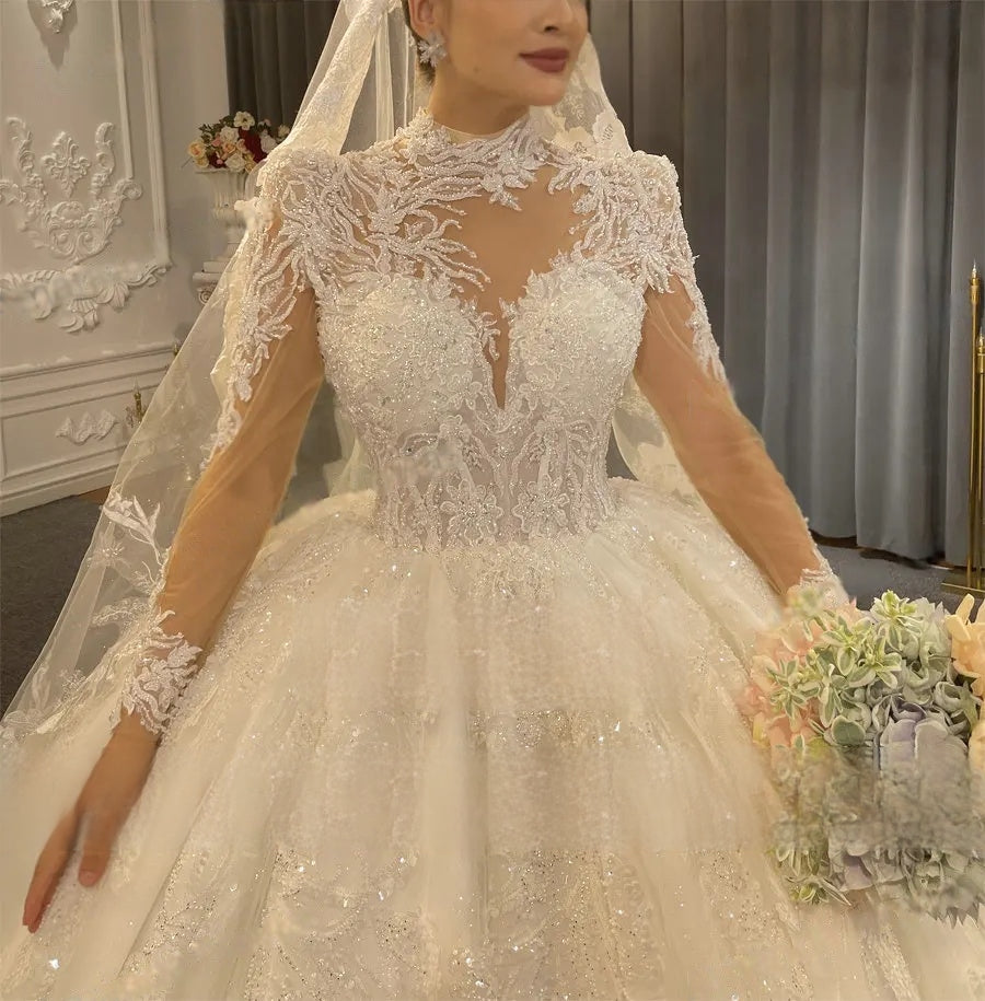 Detailed close-up of a luxury wedding dress bodice featuring a high-neck lace collar, exquisite hand-sewn crystal beading, and delicate pearl accents on long sleeves.