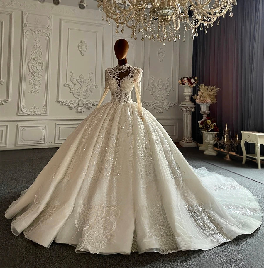 Angled front perspective of an exquisite ball gown wedding dress on a model, demonstrating the structural volume of the sparkling lace skirt and the elegant sheer bodice details.