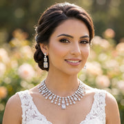 Model wearing a premium geometric bridal necklace and earring set with square and emerald-cut cubic zirconia accents.