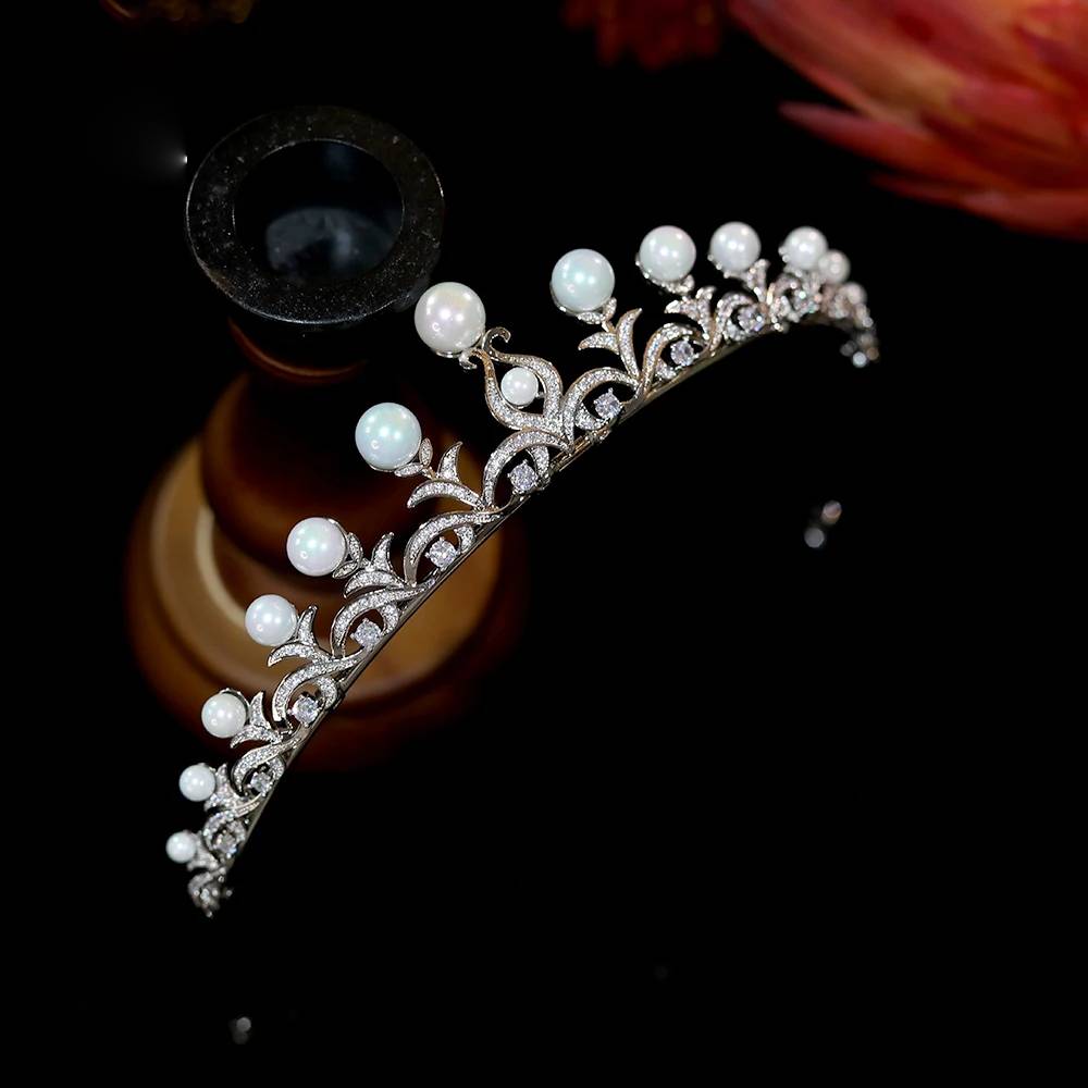 High-angle side view of a luxury pearl crown bridal hairband, highlighting the pave set cubic zirconia wave details.