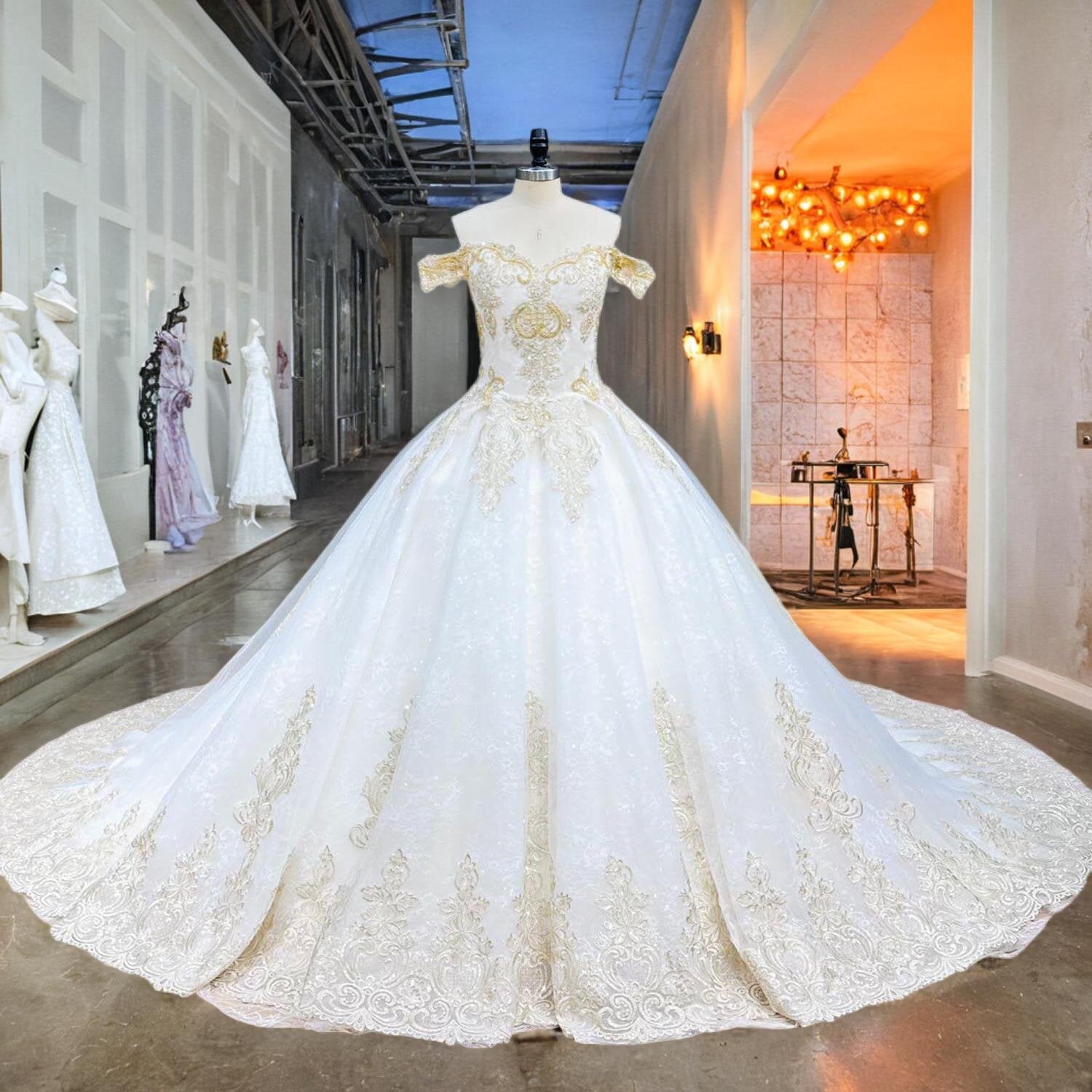 Mannequin displaying a white and gold off-shoulder ball gown wedding dress featuring intricate beaded bodice and full skirt.