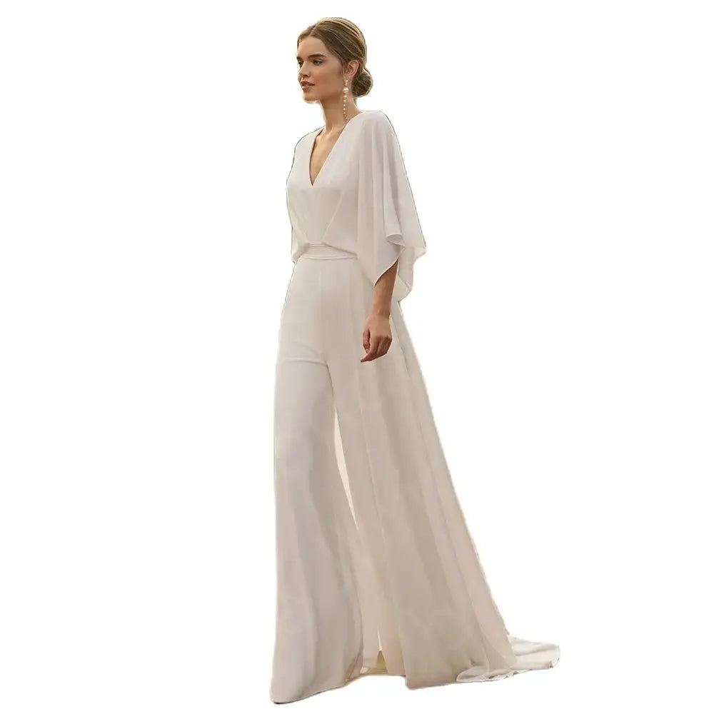 Studio product cutout on a plain white background displaying the full silhouette of the white chiffon wedding dress jumpsuit with wide legs and elegant draped sleeves.