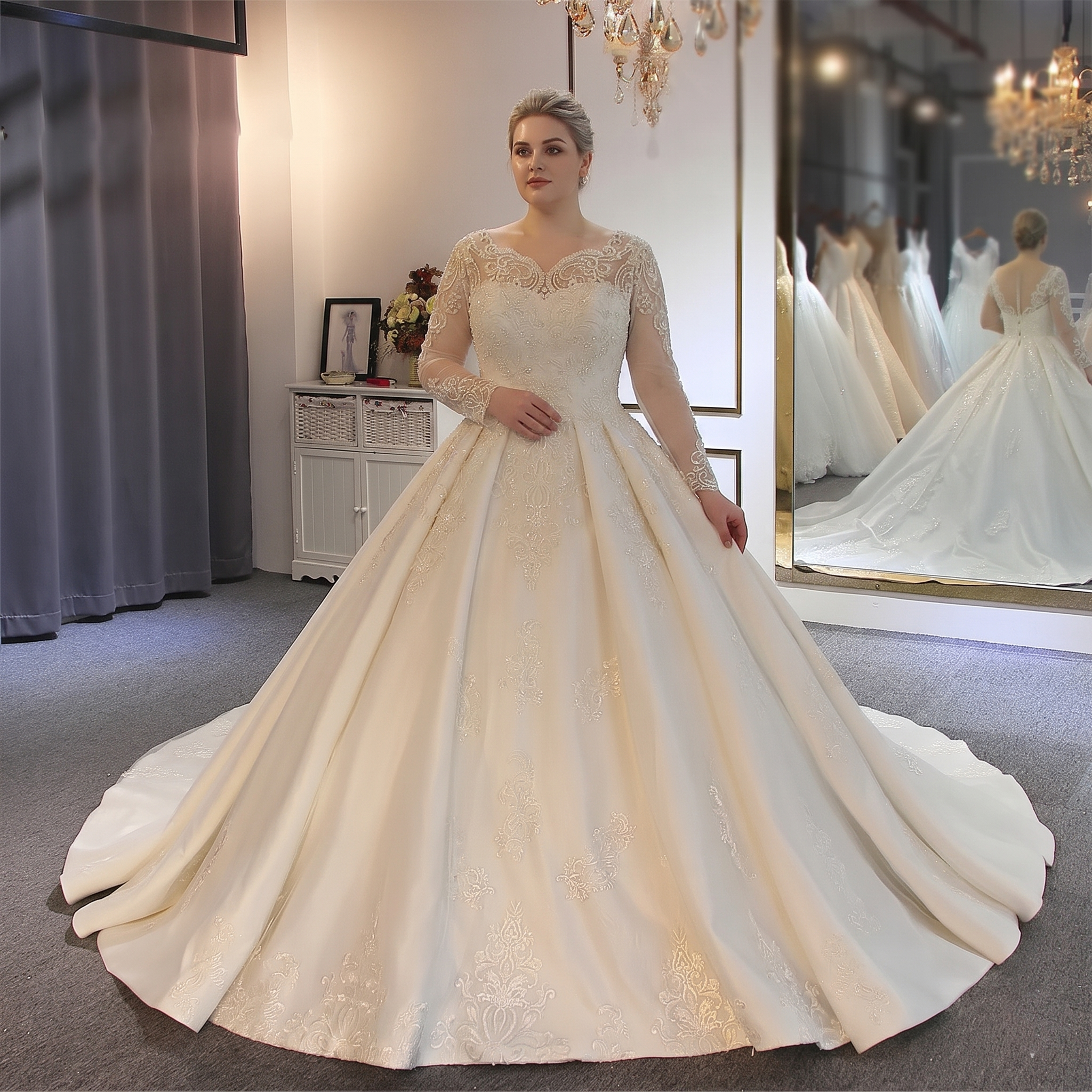 An elegant designer bridal gown featuring long lace sleeves, a delicate illusion neckline with intricate embellishments, and a full, majestic skirt in a boutique setting.