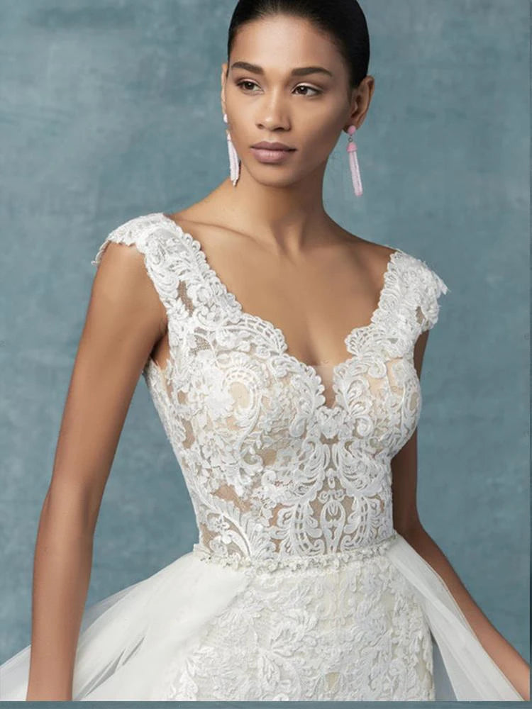 A close-up view of the intricate lace bodice detailing on a modern bridal jumpsuit.