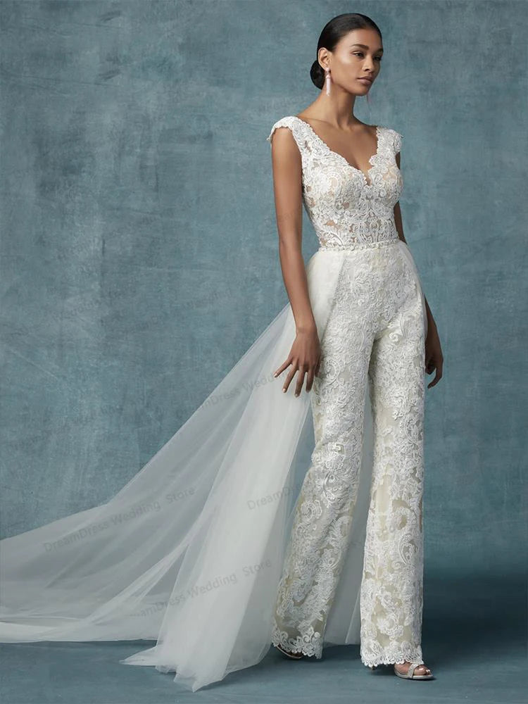 Full-length view of a white lace wedding jumpsuit with a detachable train, perfect for a modern bridal outfit.