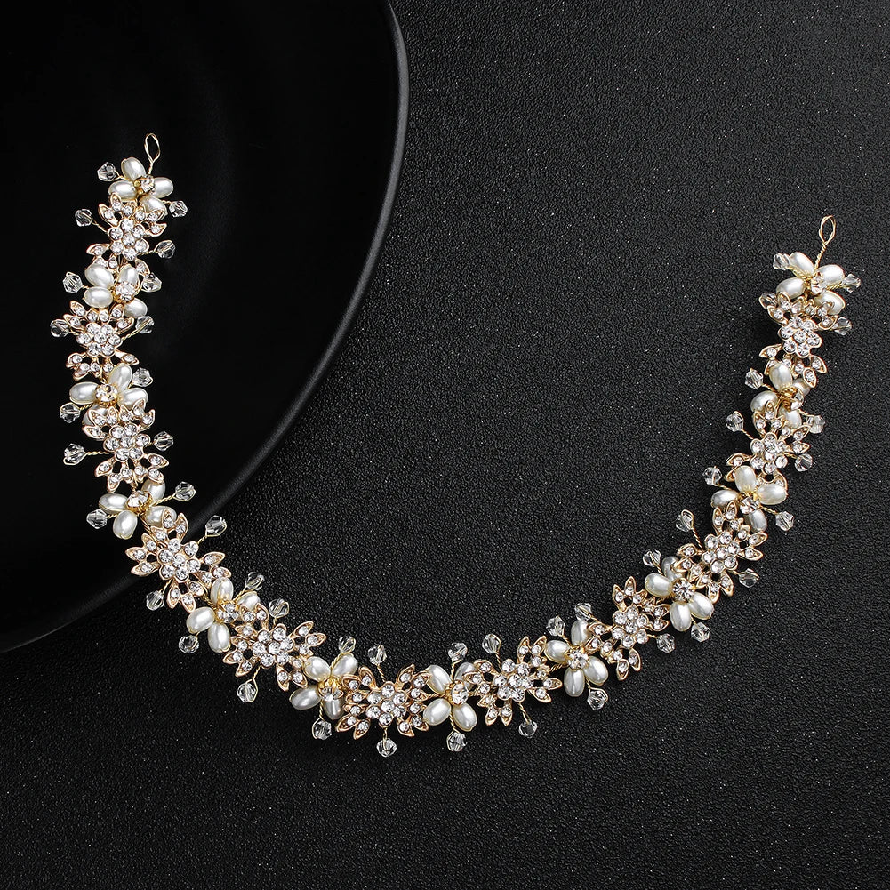 Overhead view of a flexible pearl and crystal flower bridal hairband arranged in a semi-circle.
