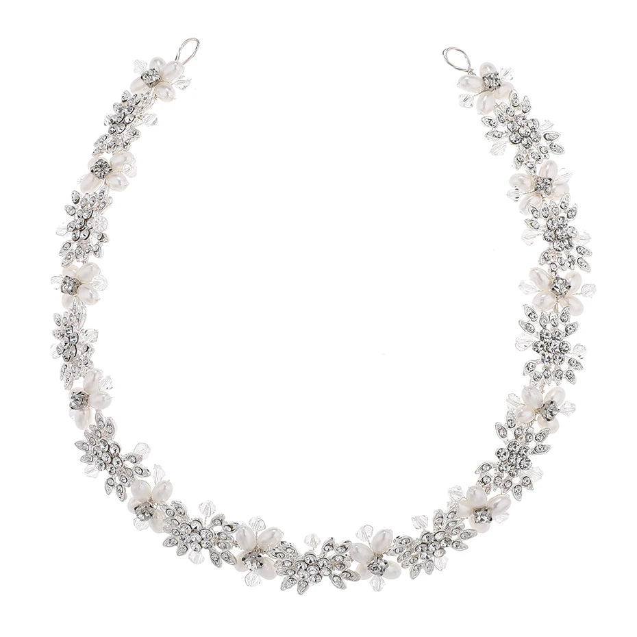 A full view of a floral pearl bridal hairband arranged in a curve, showcasing its length and flexible design.