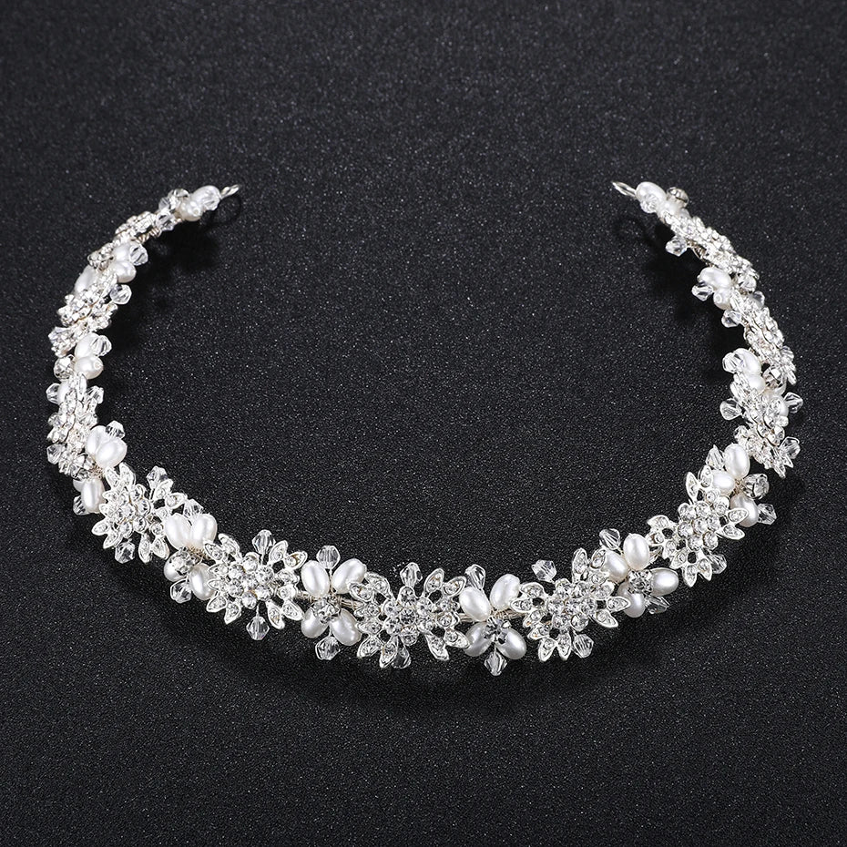 Close-up view of a silver pearl and crystal flower wedding hair accessory, highlighting the craftsmanship.