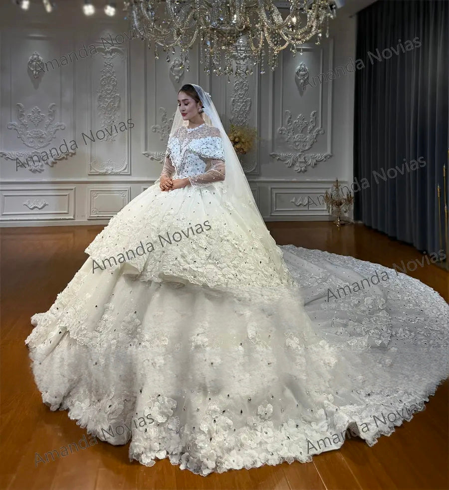 Breathtaking rear view of a layered ball gown wedding dress highlighting a traditional lace-up corset back and an expansive, shimmering tiered cathedral-length train with lace flower details.