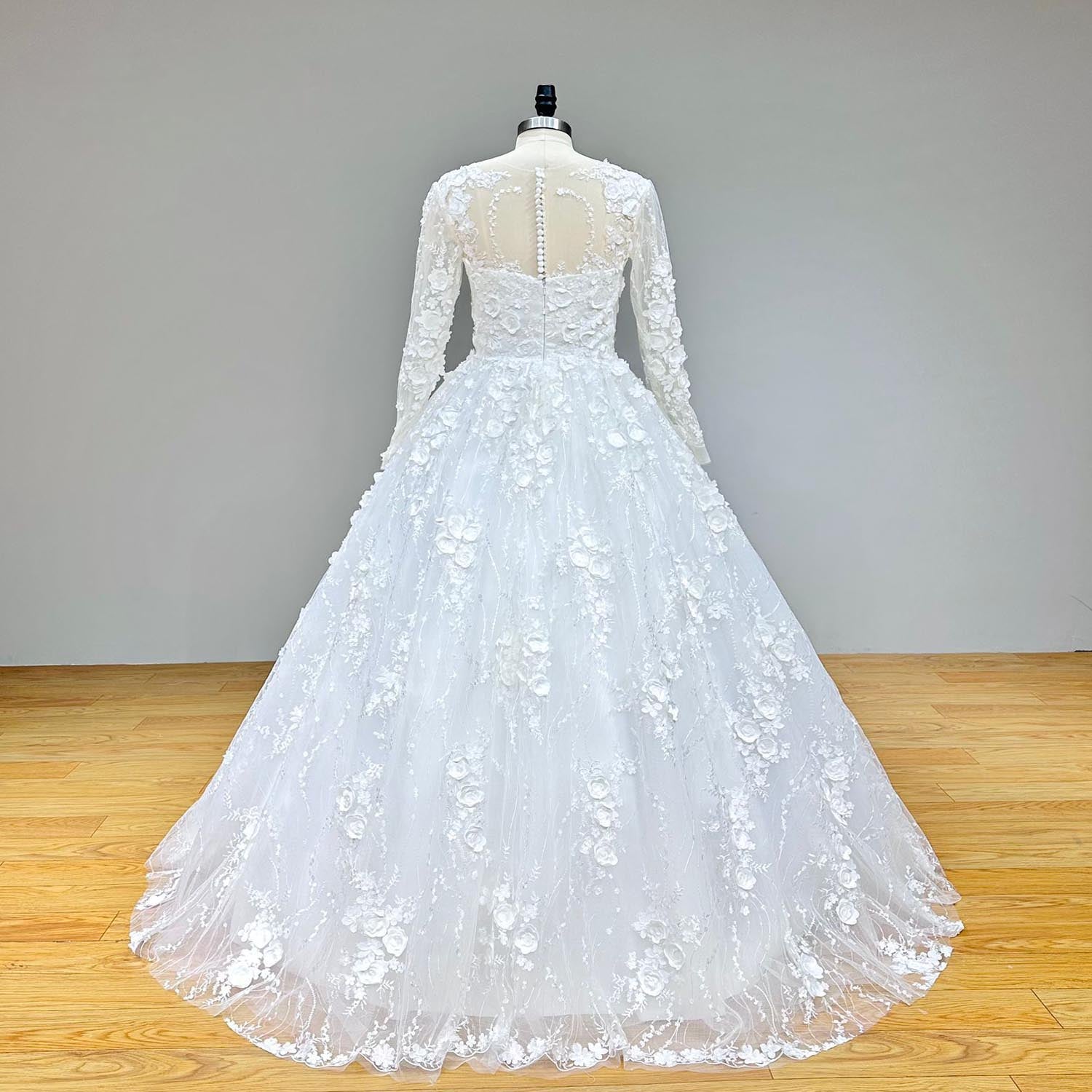 Back view of a long-sleeve floral lace ball gown wedding dress with a dramatic train and elegant button-up closure.