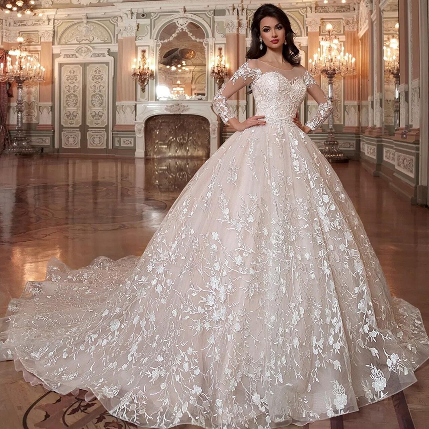Elegant bride in a grand wedding venue wearing a long sleeve ball gown wedding dress, featuring a crystal beading belt and a modern cut-out back design.