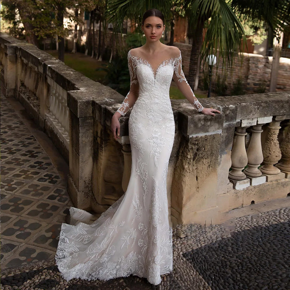 Close-up detail of the bodice and long sleeves on a beaded and sequined mermaid bridal gown, highlighting exquisite craftsmanship.