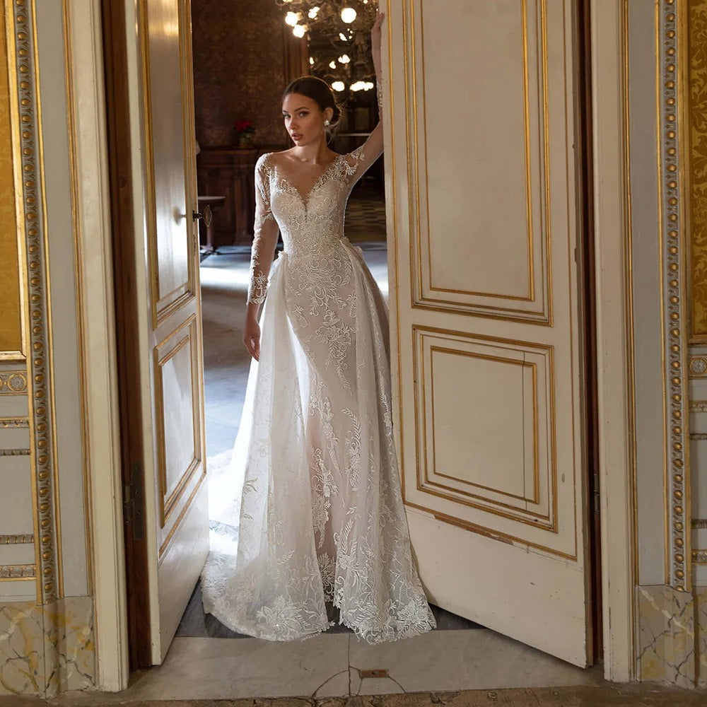 Studio mannequin view of a luxury mermaid wedding dress with long sleeves, sequins, and a detachable train, perfect for a grand bridal entrance