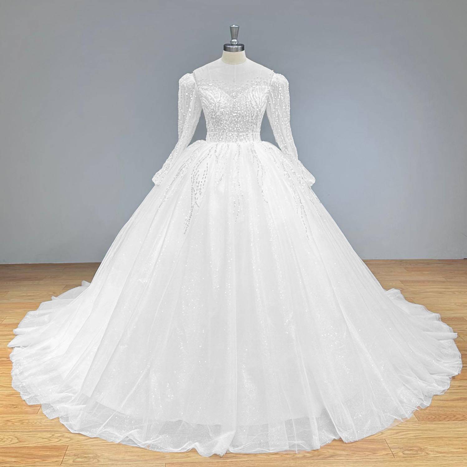 Classic full front view of a long sleeve glitter wedding dress on a mannequin, perfectly displaying the regal ballgown silhouette, shimmering tulle, and detailed sequined beading.