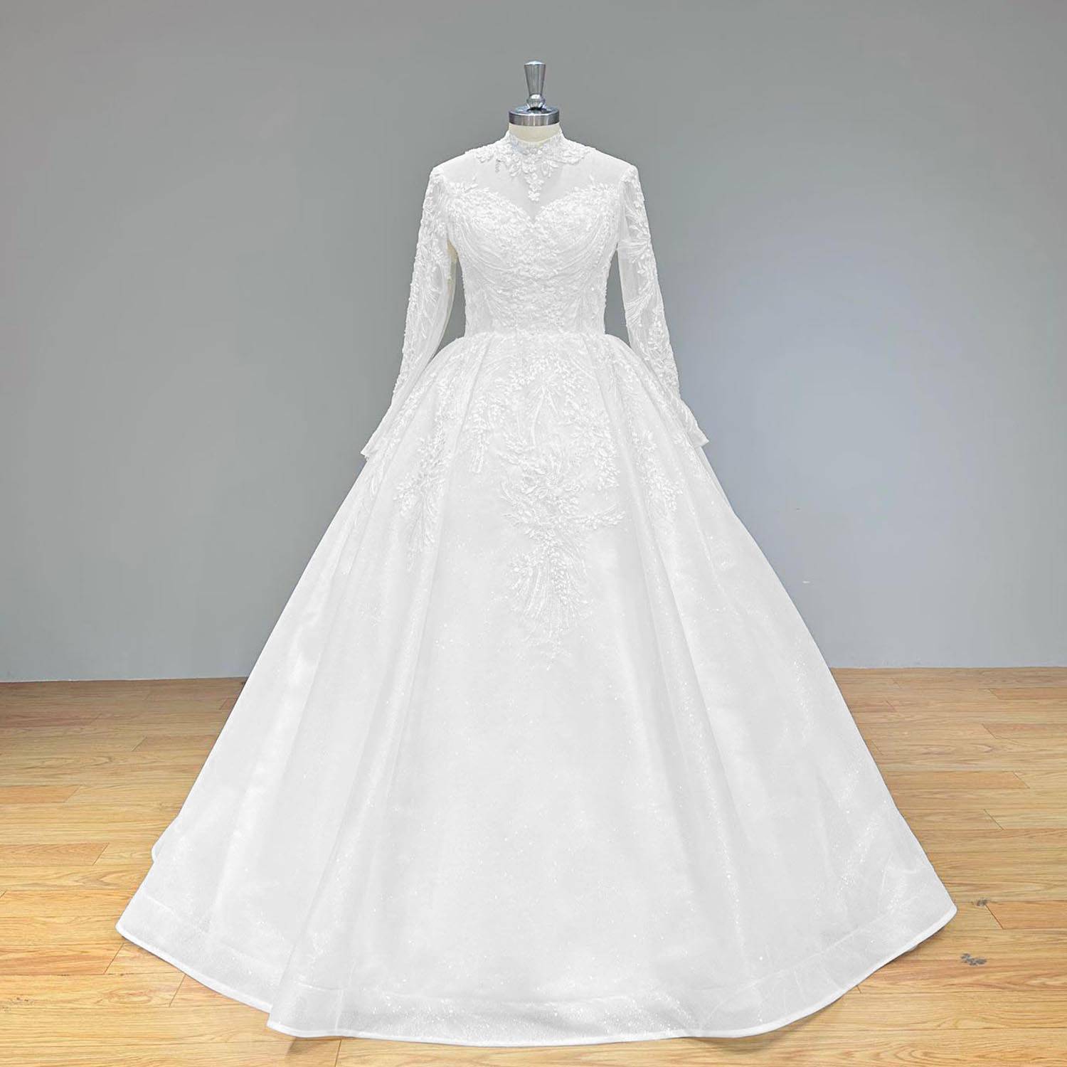 Elegant full front view of a long sleeve high neck sequined beaded wedding dress on a mannequin, featuring a classic, regal silhouette with intricate lace and bead appliques trailing down the skirt.