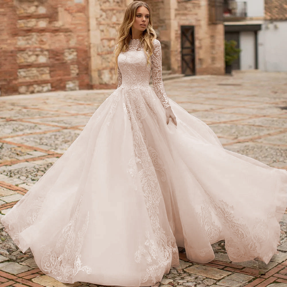 Full-length view of a vintage-style A-line bridal gown featuring delicate lace long sleeves and a sweeping skirt.