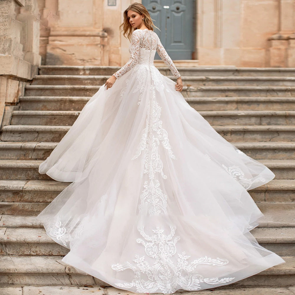 Rear perspective of a luxury vintage-inspired wedding dress with a dramatic court train and ornate lace appliques.