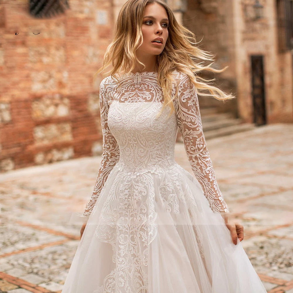 Close-up of the long sleeve lace bodice on a luxury A-line bridal gown with a refined scoop neckline.