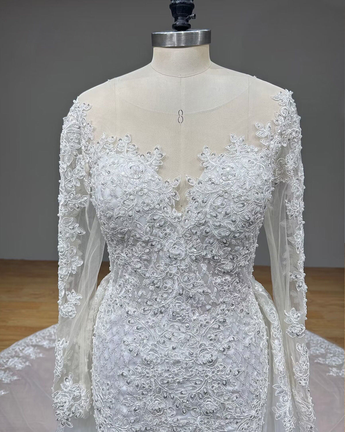 Front view focus of the vintage mermaid gown bodice on a mannequin, showcasing the illusion plunge neckline and form-fitting silhouette down to the hips.