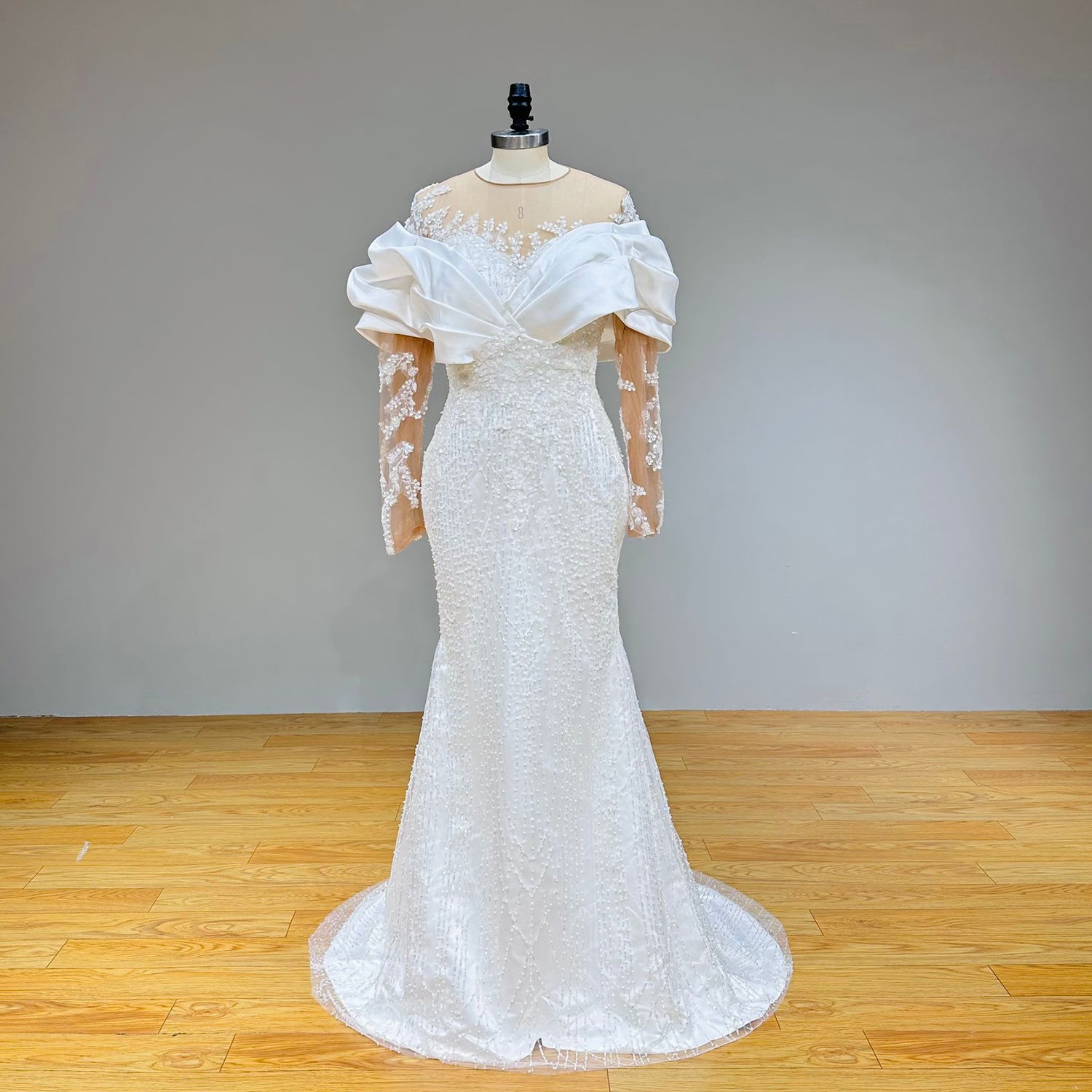 Front display of the inner mermaid wedding dress showcasing a slender silhouette fully embellished with dense crystal beading and floral lace appliques.