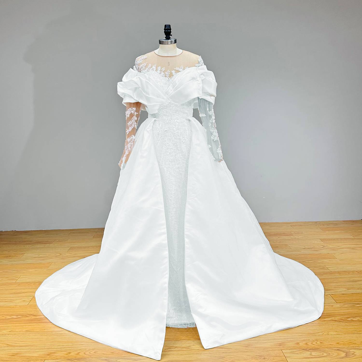 Luxury convertible wedding dress showing a sleek inner sequined trumpet dress paired with a box-pleated satin open-front overskirt train.