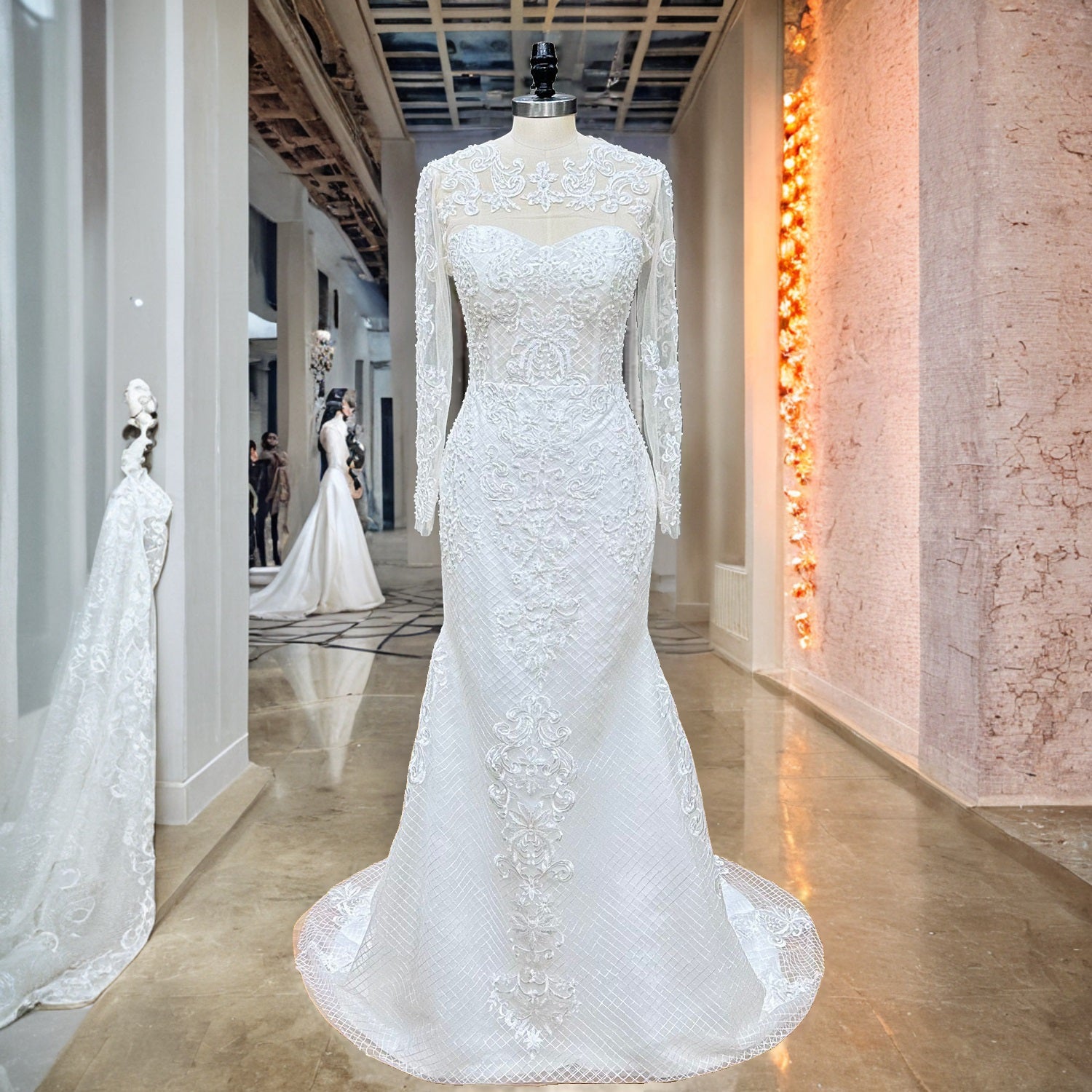 Front view of a fitted trumpet wedding dress featuring a sheer high-neck lace jacket overlay displayed on a boutique showroom mannequin.