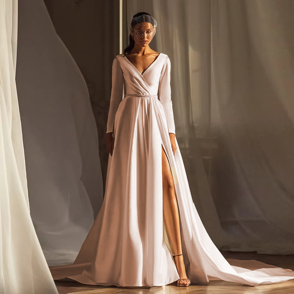 Warm champagne-tinted satin long sleeve wedding dress with a draped wrap bodice, perfect for a modern or non-traditional bride.