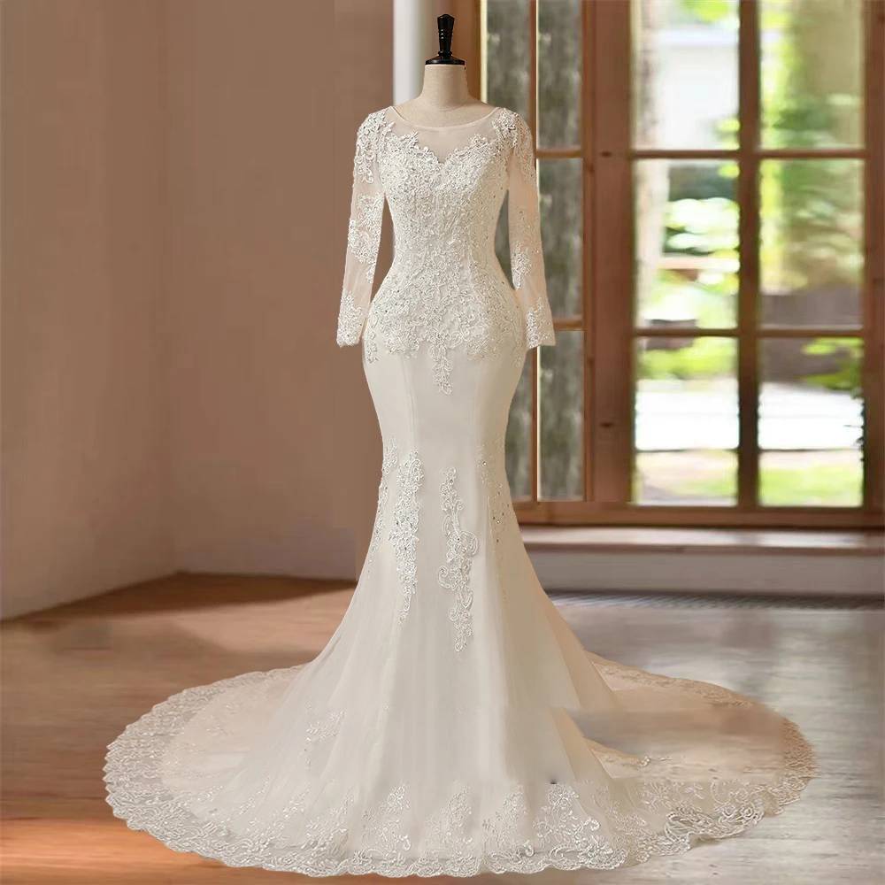 Front studio view of a luxury long sleeve mermaid wedding dress on a mannequin, highlighting the tailored hourglass bodice, sheer lace sleeves, and a flared tulle skirt.