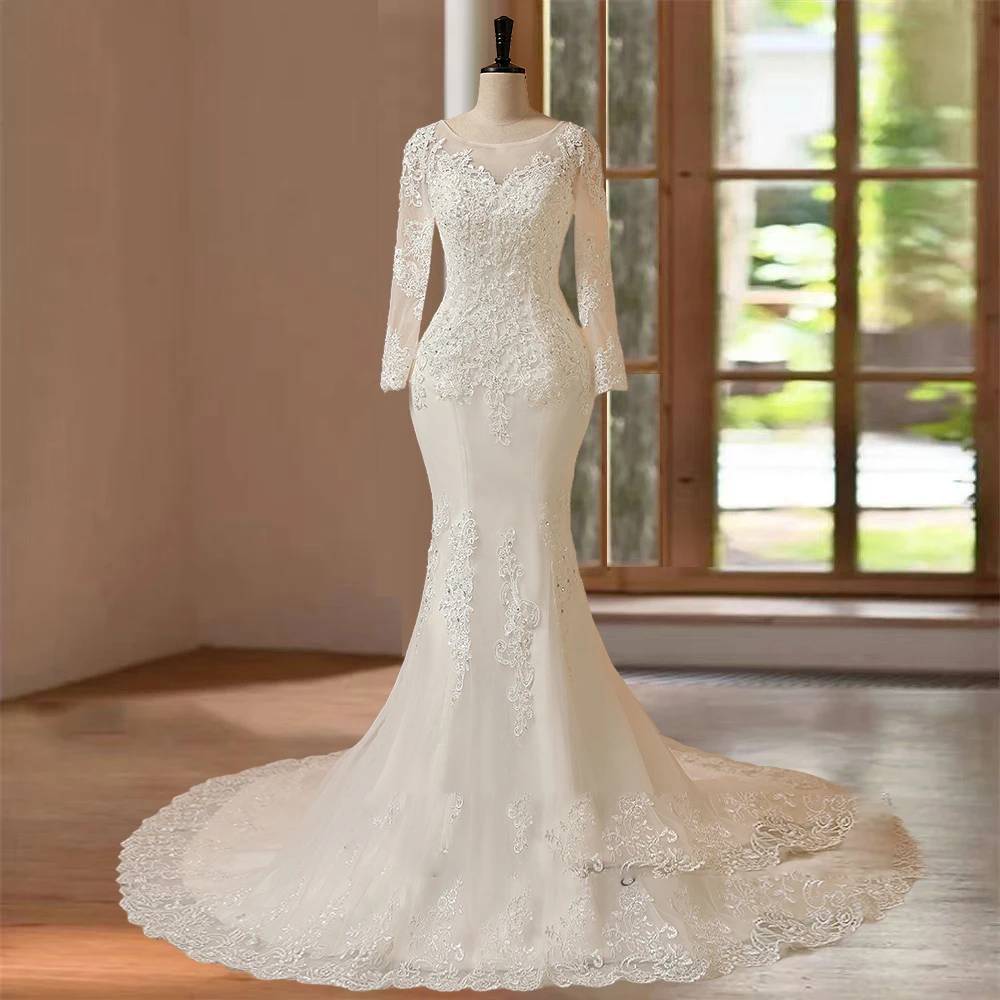 Classic front-facing display of a formal long sleeve mermaid wedding dress with an illusion lace neckline, cinched waistline, and a sweeping romantic train with scalloped lace edging.