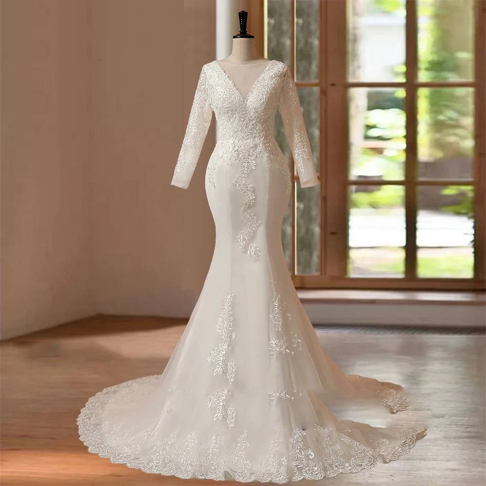 Front studio display of a long sleeve O-neck mermaid wedding dress on a mannequin, highlighting the sheer illusion jewel neckline, intricate floral lace embroidery, and a flared trumpet skirt.